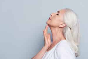 A profile shot of a woman showing the results of a neck lift in Denver, CO